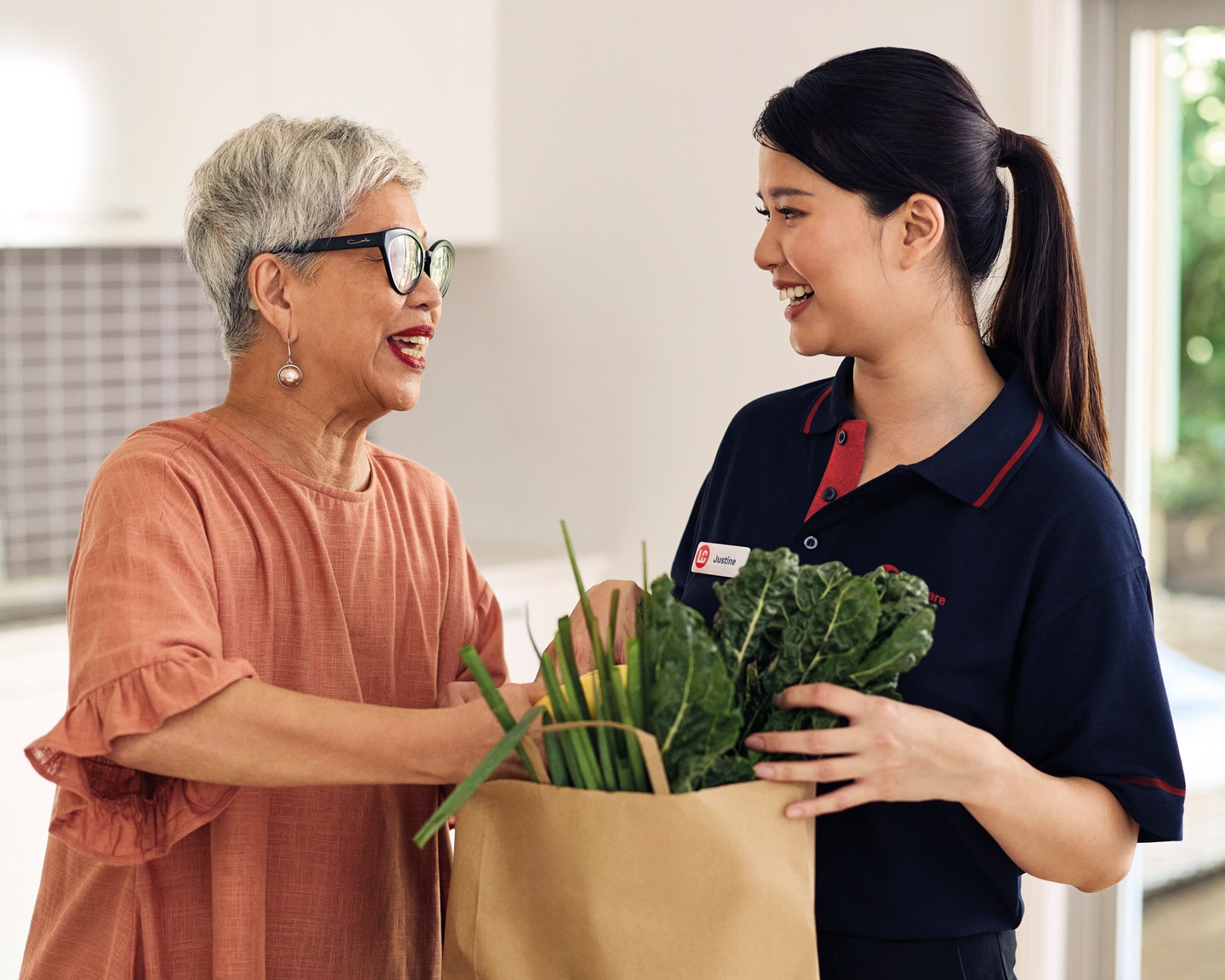 St Quentin Place - staff member assisting resident with groceries